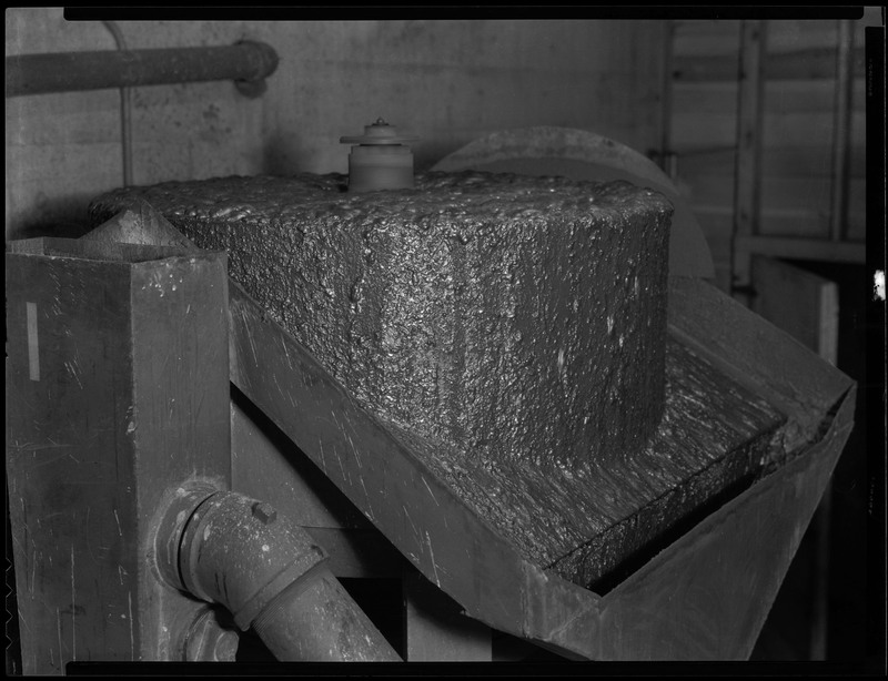 Image of an upclose part of mining machinery within an unidentified mine.