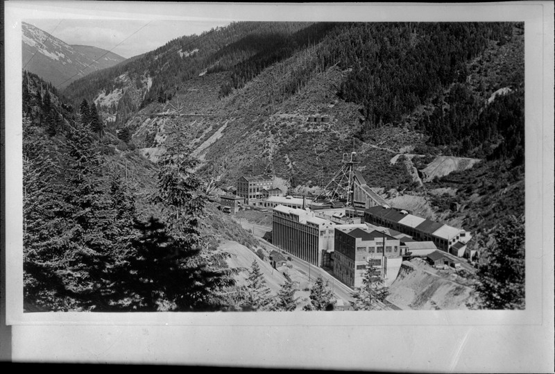 Image of a photograph overlooking Hecla Mine buildings and the surrounding tree covered area.