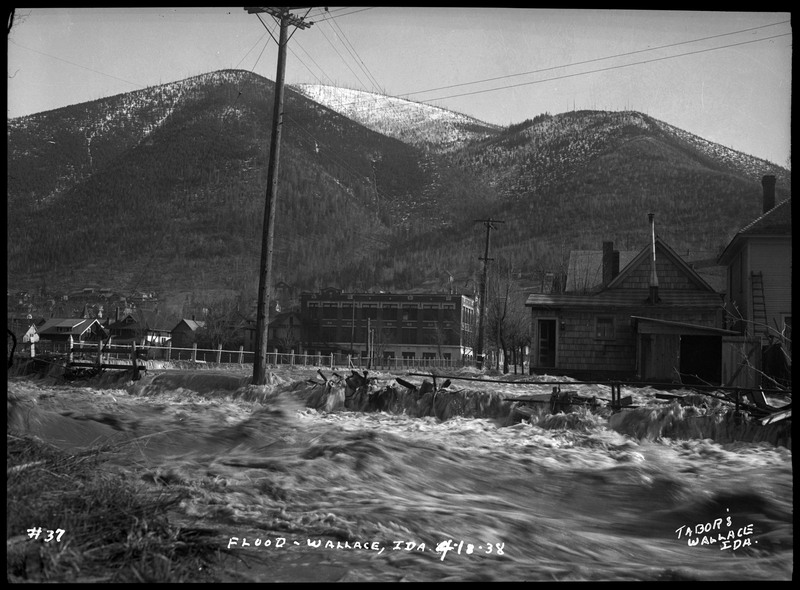 A south-facing image of Wallace, ID during a flood. Centered in the picture is Wallace High School. 