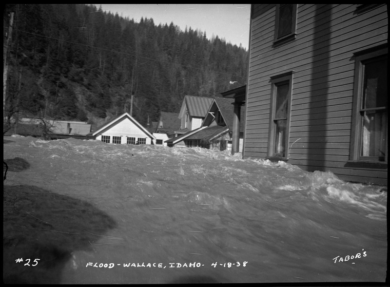 The Wallace, Idaho flood with water rushing against residential houses.