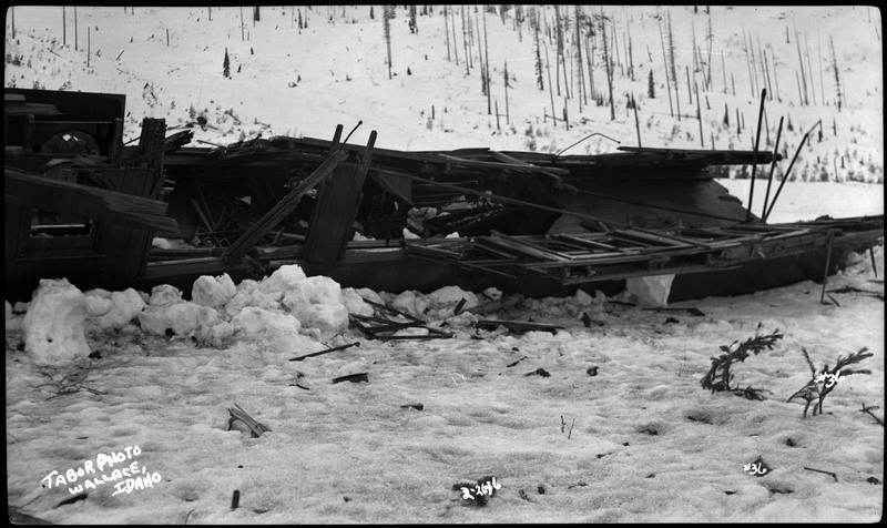 The damage caused by a flood near Wallace, Idaho. This shows a destroyed structure in the snow.