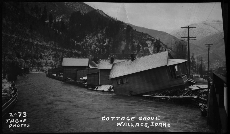Cottage Grove in Wallace, Idaho during a flood. Several of the buildings pictured are damaged.