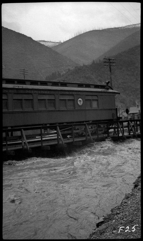 A train car near the flooding in Wallace, Idaho. The water nearly reaches the tracks that the train car is on.