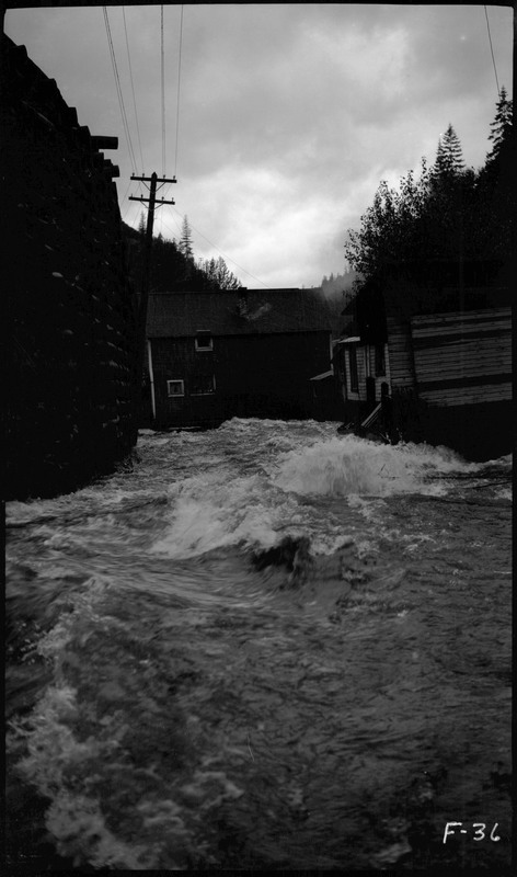 Water rushing towards a building during the Placer Creek flood.