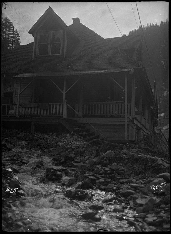 Image of water nearing a house during a flood in Wallace, Idaho.