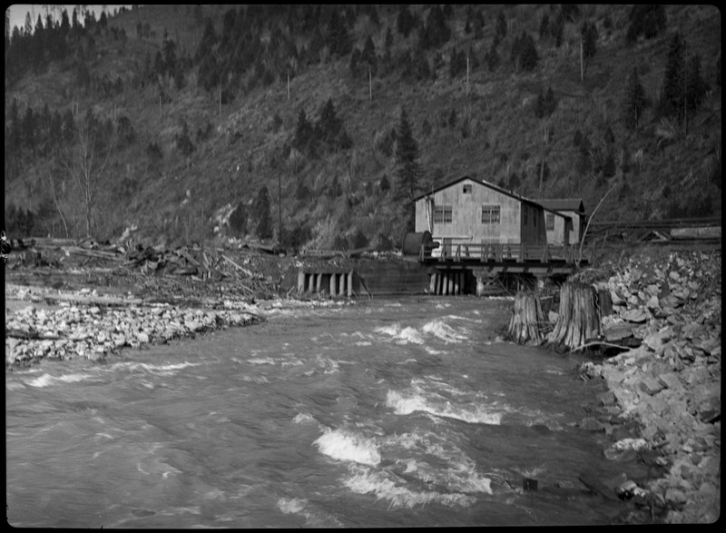 Water during a flood in Wallace Idaho. A few buildings are in the distance.