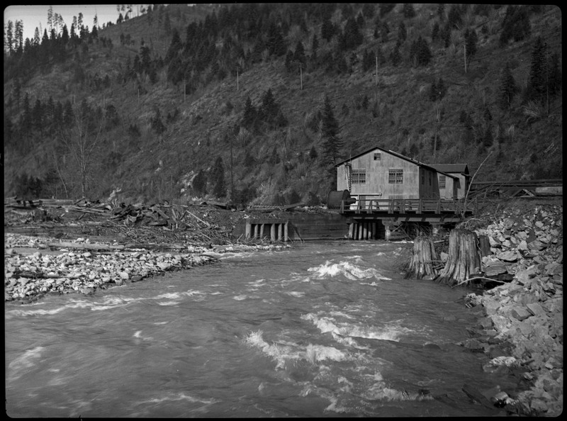 Water during a flood in Wallace Idaho. A few buildings are in the distance.