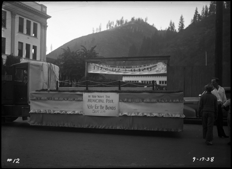 Empty voting float during the Benevolent and Protective Order of Elks Roundup parade. Text on the float reads, "If You Want The Municipal Pool Vote for the Bonds Sept 27th."
