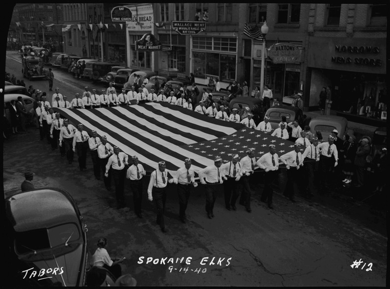 The Spokane Elks holding an American flag in the Elks Roundup parade.