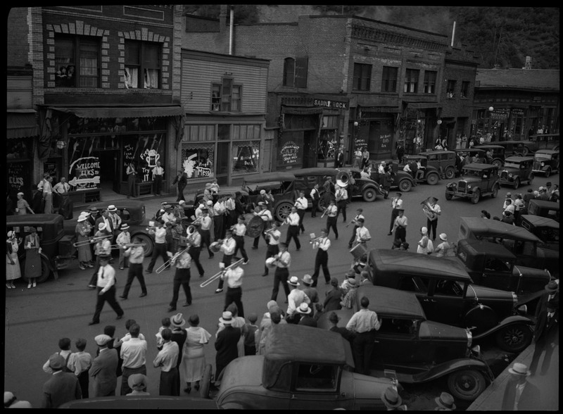Young boys in a marching band during the Benevolent and Protective Order of Elks parade. Spectators watch from the sides of the street.