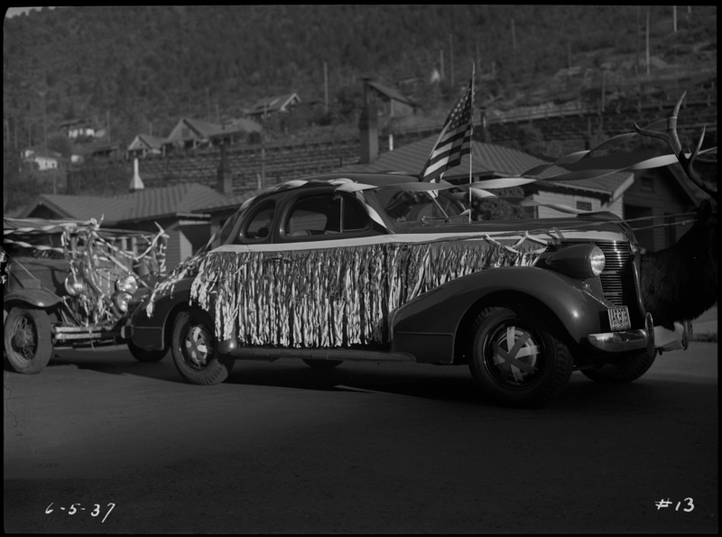 A car decorated with an American flag, the head of an elk, and streamers during the Benevolent and Protective Order of Elks roundup parade. 