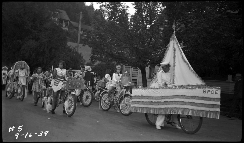 Children riding decorated bicycles during the Benevolent and Protective Order of Elks roundup parade.