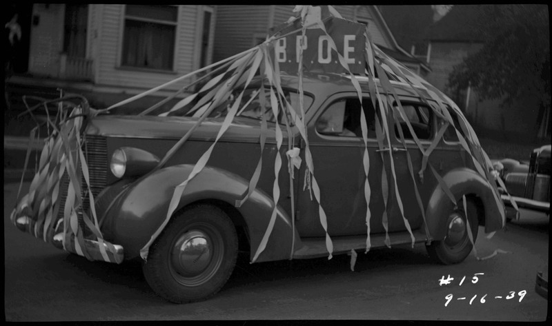 Vehicle decorated with streamers and a sign that reads, "B.P.O.E." during the Benevolent and Protective Order of Elks parade.