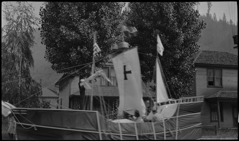 A float decorated to look like a ship passes by during the Benevolent and Protective Order of Elks day parade. At least one person is on the float.