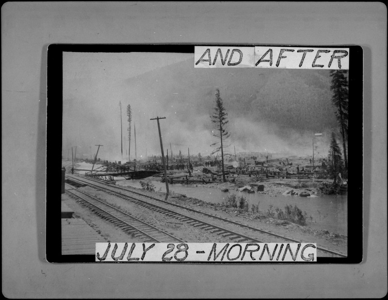 An image of a photograph showing Wallace after a fire. The landscape is barren and there is extensive damage. The text around the photograph reads, "AND AFTER JULY 28-MORNING."
