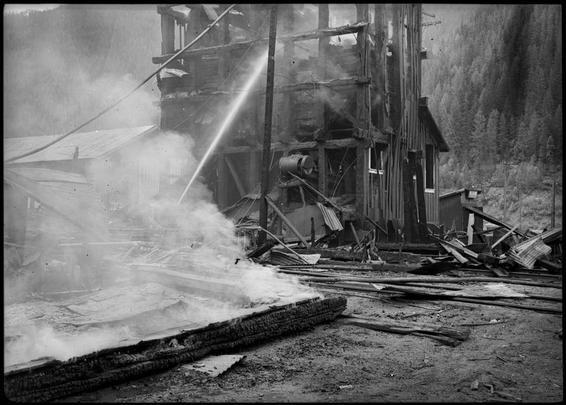Damage from a fire at Morning Mill. A stream of water can be seen angled at the damaged building.