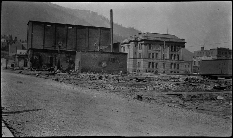 Building ruins in Wallace following a fire. There are buildings still standing in the background.
