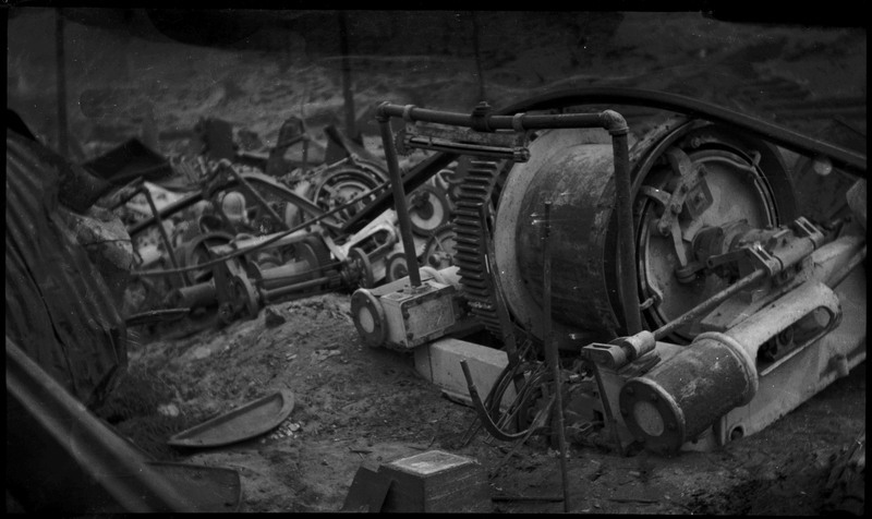 Closeup image of machinery among the ruins of a fire.