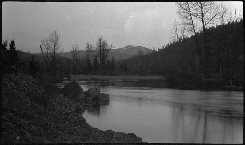 A body of water and surrounding forested area in Wallace, possibly around the time of the 1910 Wallace fire.