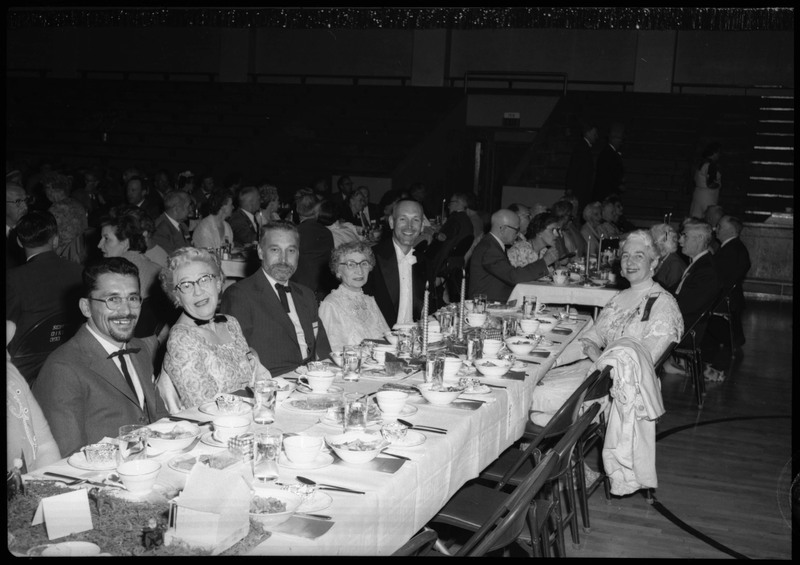 People dressed in formal wear seated at tables during the Silver Jubilee banquet.