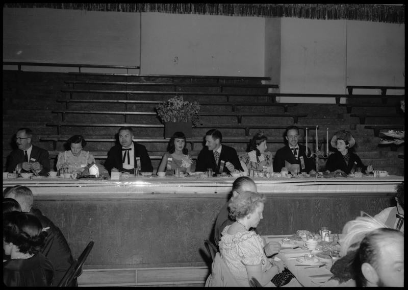 People dressed in formal wear seated at tables during the Silver Jubilee banquet.
