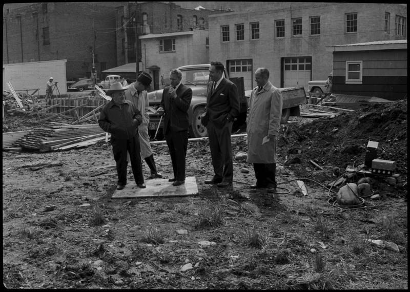 Five men standing near the construction of the Stardust Motel during its dedication.