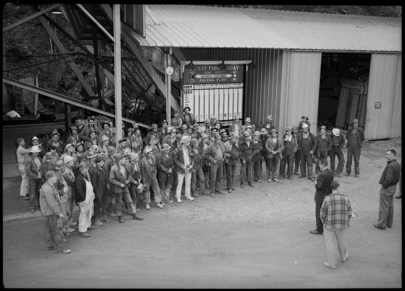 Group photograph of the workers at the Galena plant receiving the Galena Safety Award. They are standing in front of a safety board.