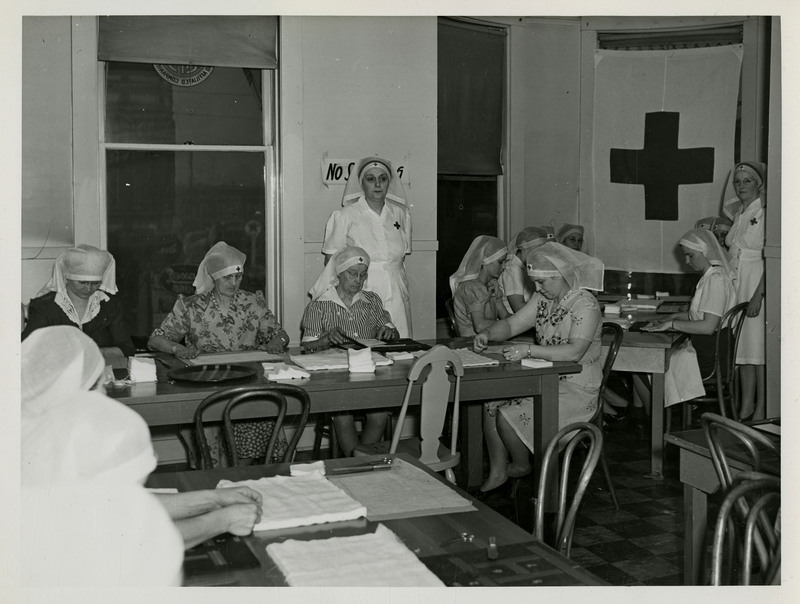American Red Cross nurses work with surgical dressing.