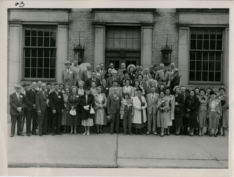 Unidentified men, women, and children in front of building in Wallace, Idaho.