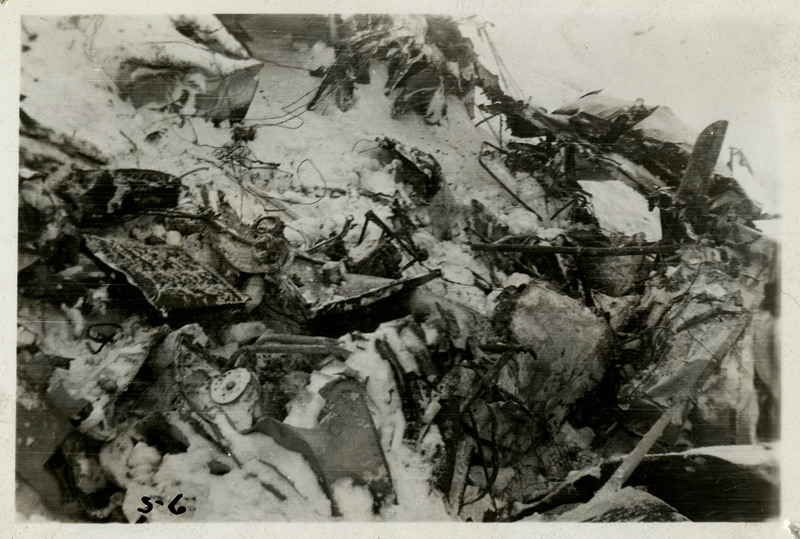 Debris from an airliner crash partially covered in snow.