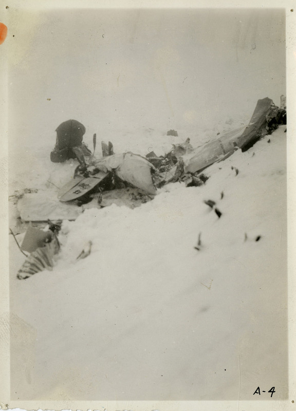 Debris from an airliner crash partially covered in snow.