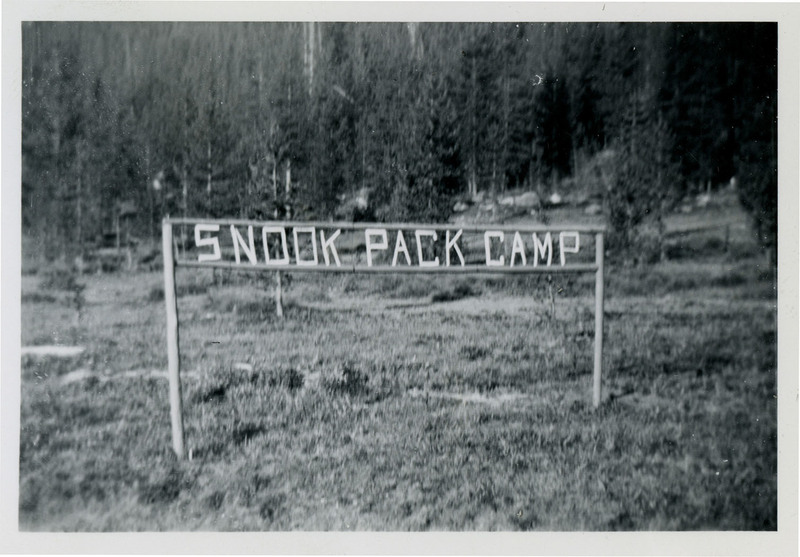 A sign reads "Snook Pack Camp." Trees in the background.