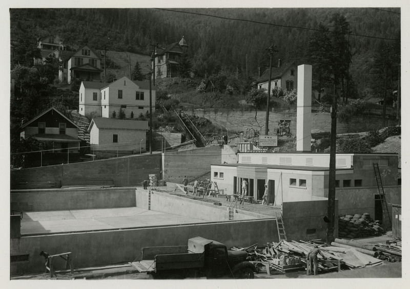 A view of the Wallace swimming pool under construction. Several workers are working on the deck. The Wallace Swimming Pool was built in 1939 and located at 604 Hotel Street Wallace, Idaho.