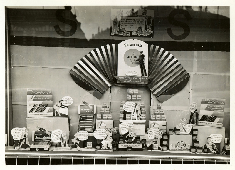 Display of writing tools, office and school supplies in the window of the Tabor store.