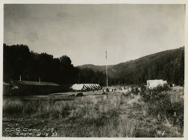 A view of the Civilian Conservation Corps Eagle Camp in Wallace. Vegetation and trees surround the camp and buildings.