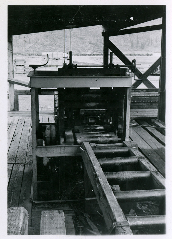 Photograph of mining machinery outside under an overhang.