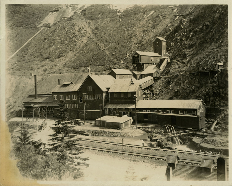 View of the Tamarack Mill buildings. A rail track can be seen in front of the buildings.