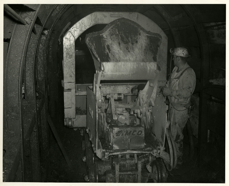 A miner working with mining machinery.
