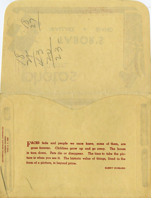 Peach colored photograph envelope with red illustrations and details. Handwritten text on the outside flap reads "Snow Scenes of Wallace."