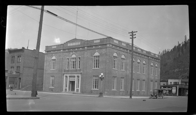 Photo of the Benevolent and Protective Order of Elks building in what is likely Wallace, Idaho. There is a car parked on the side of the road next to the building.
