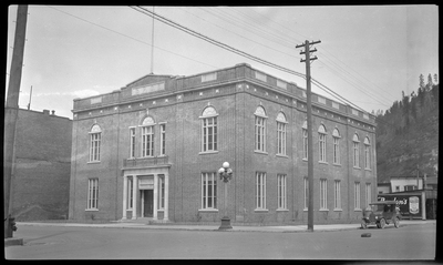 Photo of the Benevolent and Protective Order of Elks building in what is likely Wallace, Idaho. There is a car parked on the side of the road next to the building.