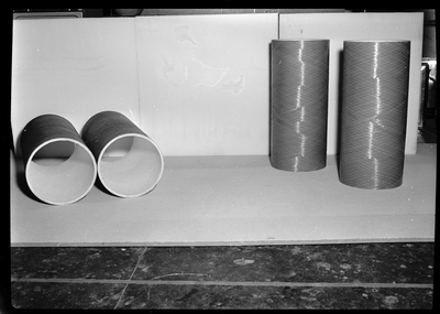 Photo of Spunstrand Incorporated equipment in a room, possibly HVAC system work. There are four tubes set aside, not connected to the rest of the system.