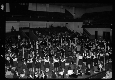Group of unidentified children gathered in a room for the Blue Bird Fly-Up. Some children are sitting and some are standing.