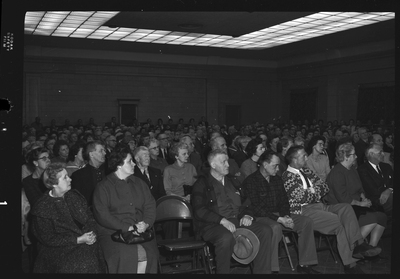 Crowd of unidentified men and women sitting in a room attending the Gyro Club Anti-Communism meeting.