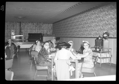 Several tables of women sitting together while eating and celebrating Mother's Day with the Benevolent and Protective Order of Elks. The women are all well dressed.