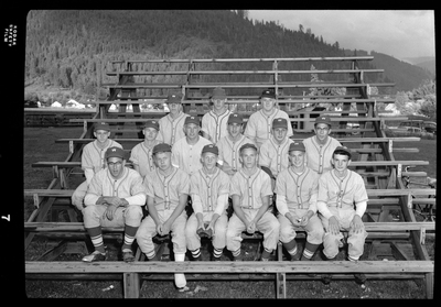 The Legion baseball team members are sitting together on bleachers for a group photo. They are wearing matching baseball uniforms.