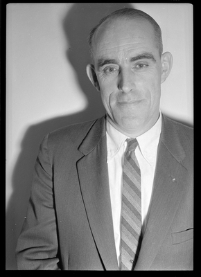 Photo of a man wearing a suit. Possibly Bill Featherstone.