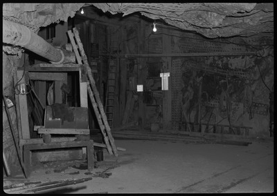 The Lucky Friday Mine main shaft with it's elevator. There are several signs throughout the mine shaft that read, "DANGER DON'T STAND NEAR SHAFT," "KEEP GATE CLOSED," "PHONE CODE 1 RING MAIN HST. 3 RINGS OUTSIDE STA. SIG. LEVELS," and "HURT MAN SIGNAL 5-4 5-4."