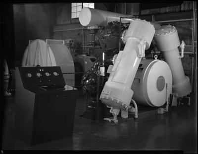 Image of the compressor in the hoist room within Galena Mine in Wallace, Idaho. The machine's operating table is visible next to it.