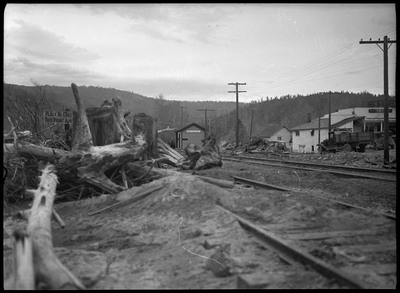 Image of the destruction following Cataldo flood. A small building with "Cataldo" on the side of it sits among the damage.